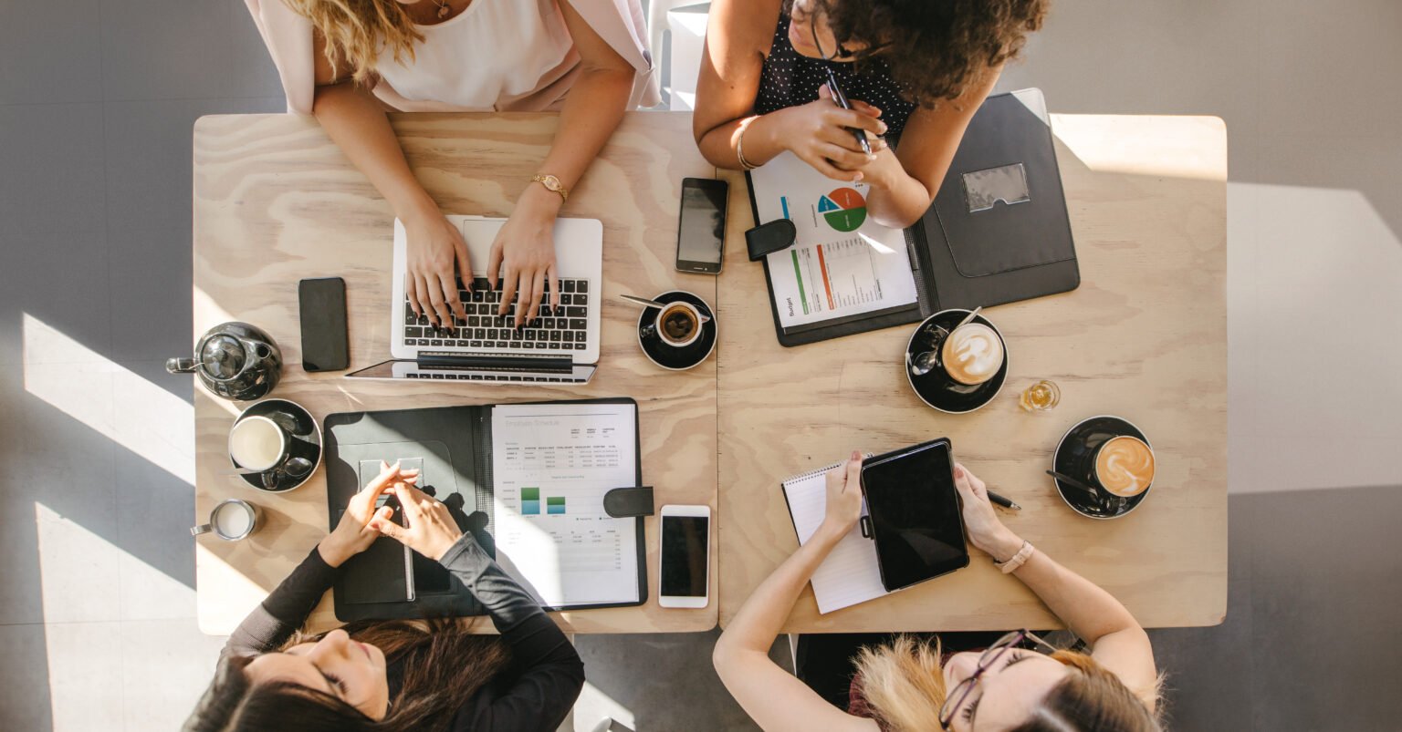 group of women working together in coffee shop